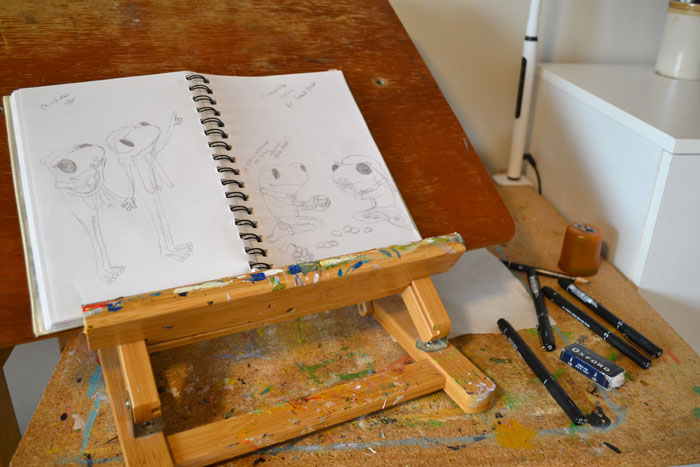 A photo of preliminary sketches by Ruth Burton Artist for the Frog's Bucket List 'Christmas Fun' book.