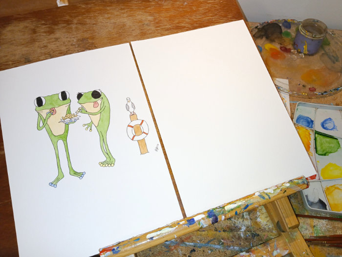 A photo the original Frog's Bucket List painting called 'Salt And Vinegar Chips' next to a blank piece of watercolour paper - ready for reworking an old painting.