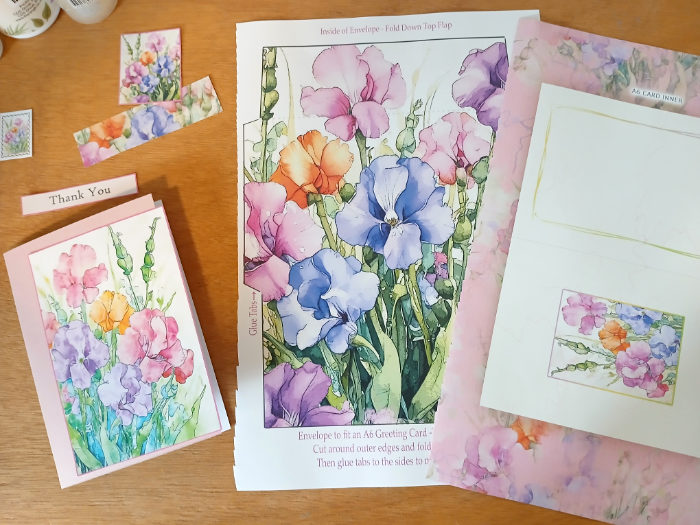 Some elements cut out from the book "Summer Flowers - A Luxury Card Making Book" by Kay Burton. The elements include card toppers, a sentiment, an envelope and a card inner.