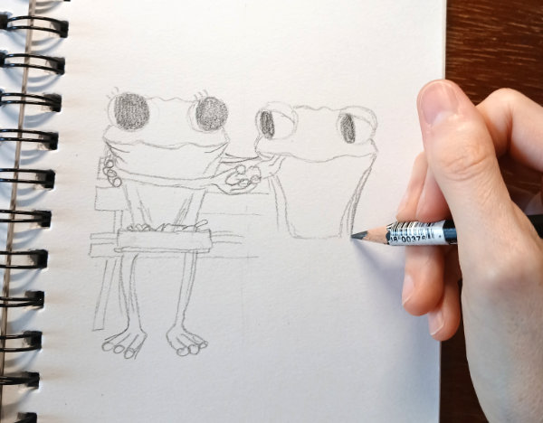 A photograph showing Ruth Burton sketching an idea for "The Lunchbox Surprise" cartoon special (part of Frog's Bucket List).