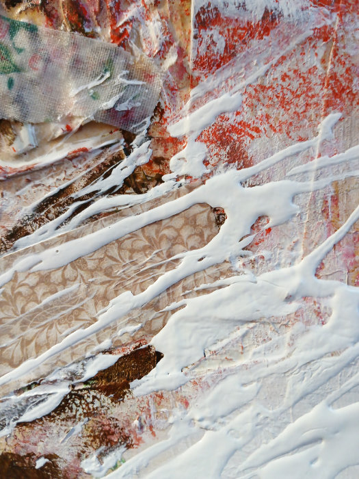 A close up of the Liquitex acrylic medium. The medium has been applied in a random, abstract way over the other art mediums.