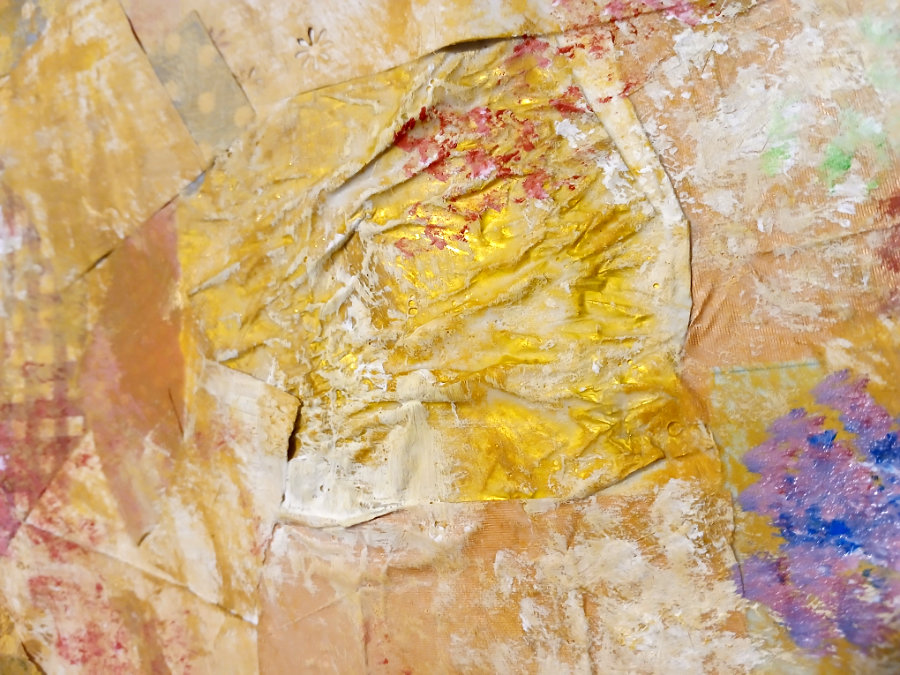 A substrate made from scrap papers and ephemera, with a scumbling effect over the top. The image is a close up of the paintwork over a sweet wrapper.