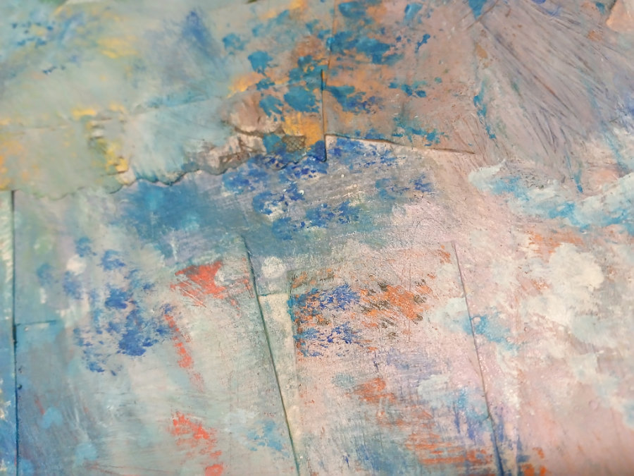 A substrate made from scrap papers and ephemera, with a stippling effect over the top. The main background colour is blue, with pink, yellow and red highlights.