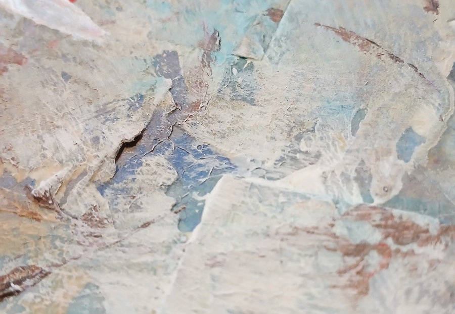 A close up of some of the textures created from the layers of ephemera and paint. The main colours are blue, white and brown.