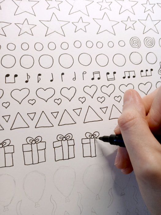 Ruth Burton outlining the pencil illustrations with a black pen for the colourful watercolour designs.