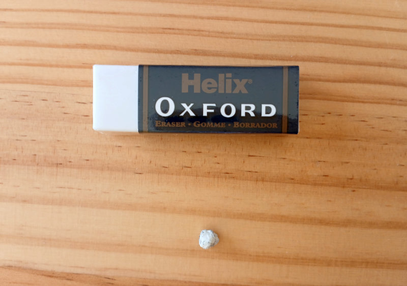 A photograph of a brand new eraser with an eraser that is almost completely used. All that remains is a small ball of eraser around 5mm diameter. The eraser was used by Ruth Burton for the Frog's Bucket List drawings and paintings.